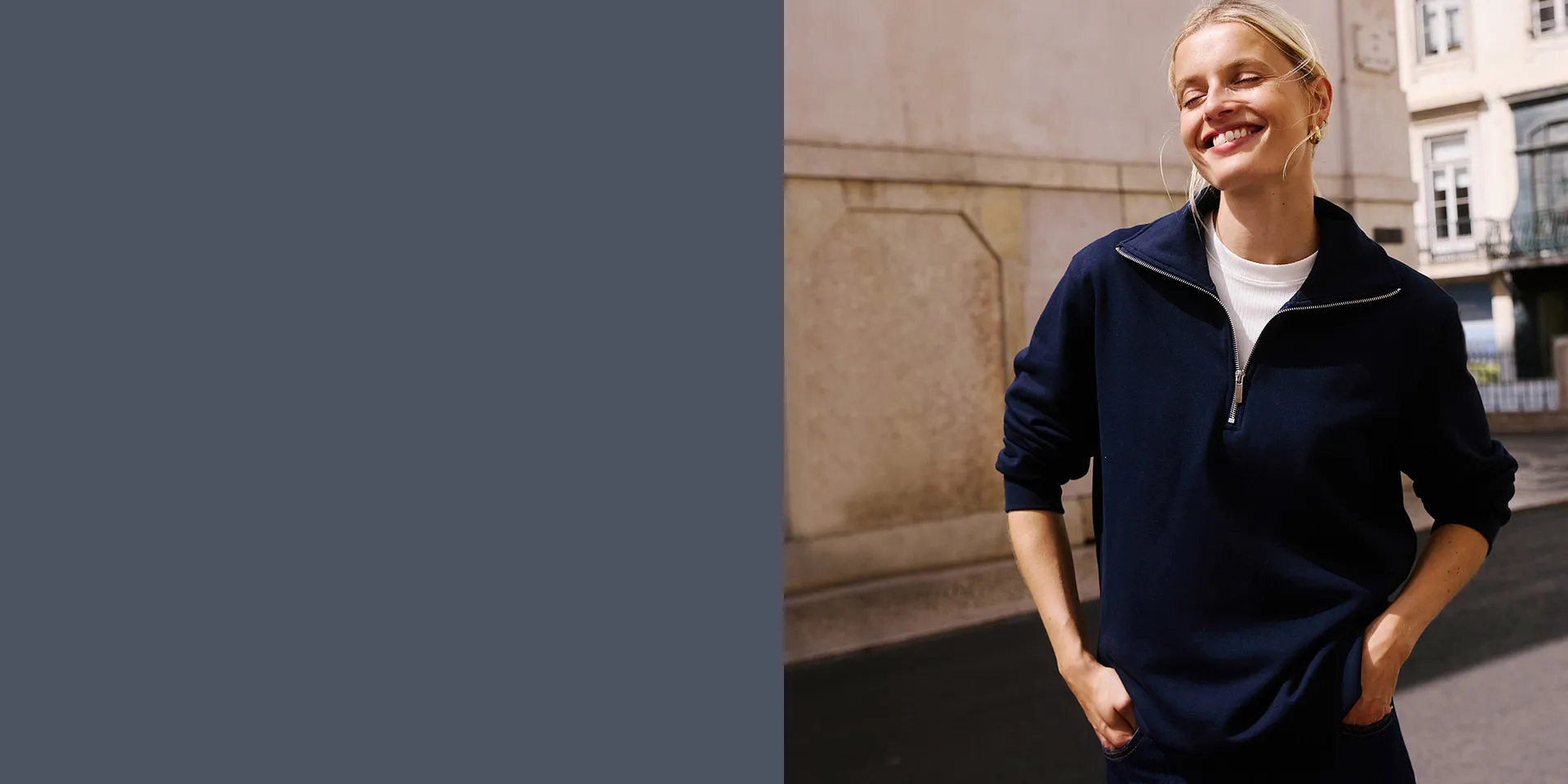 Dunkler Pullover mit Reißverschluss am Kragen.
