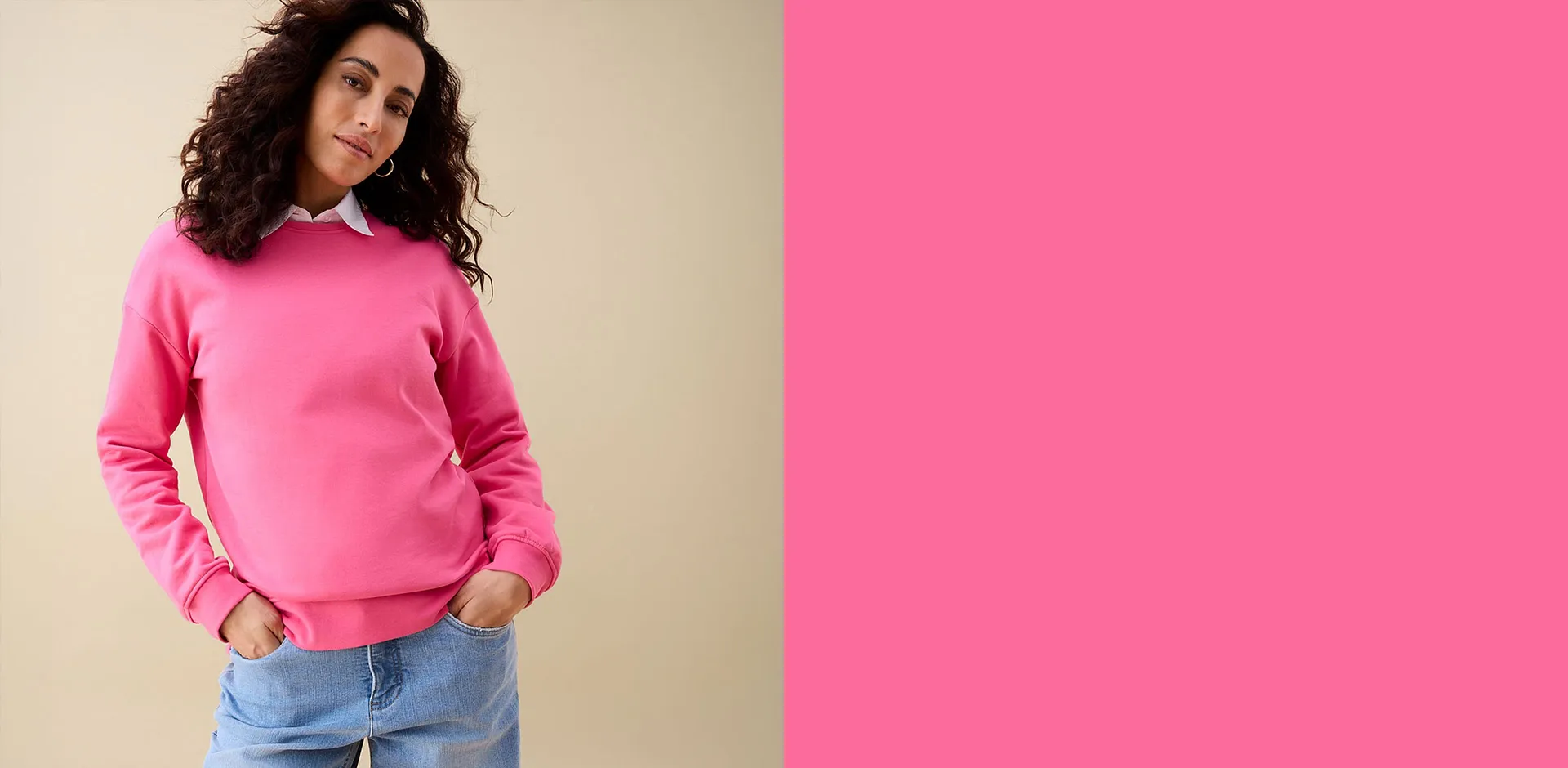 Pinkes Sweatshirt &uuml;ber wei&szlig;em Hemd, dazu l&auml;ssige blaue Jeans.