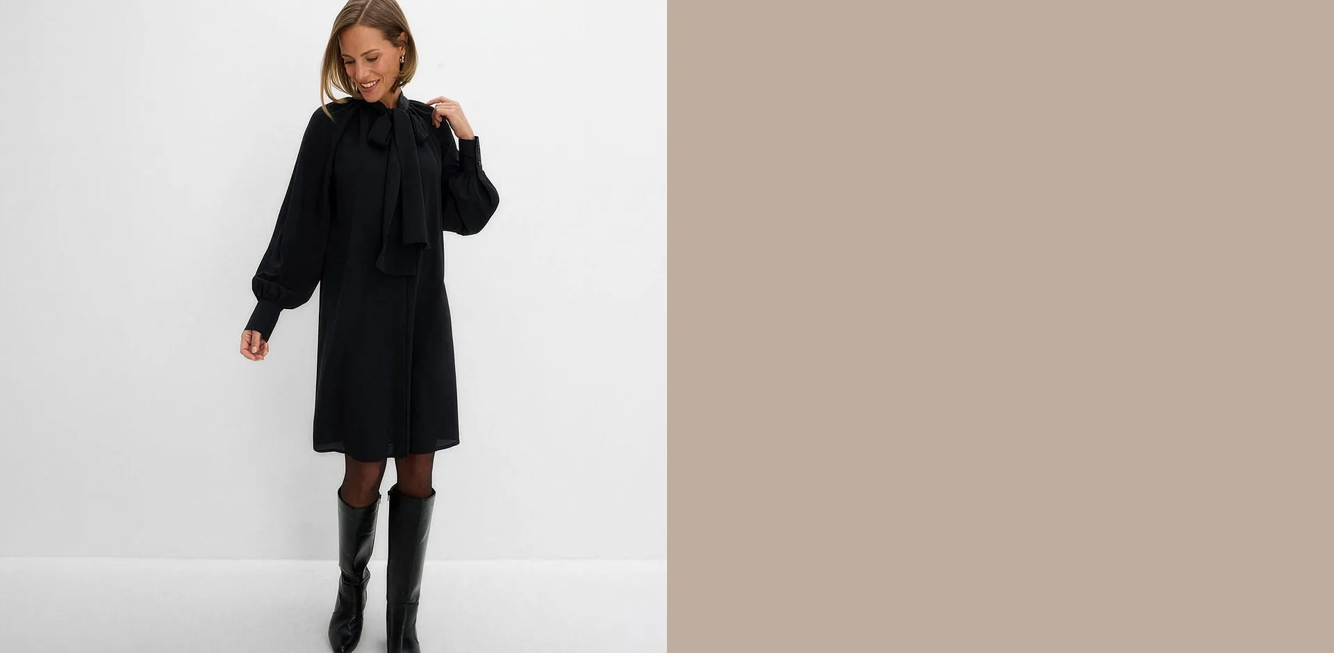 Sie tr&auml;gt einen stilvollen Pullover mit Beige und Fischgr&auml;tmuster sowie eine dunkle Hose.