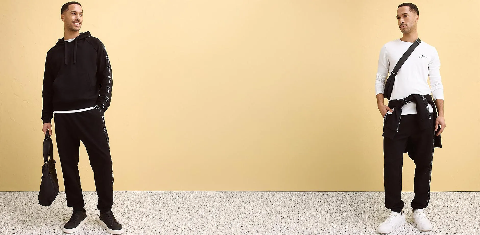 Wei&szlig;es Langarmshirt, schwarze Sweathose und schwarze Umh&auml;ngetasche.