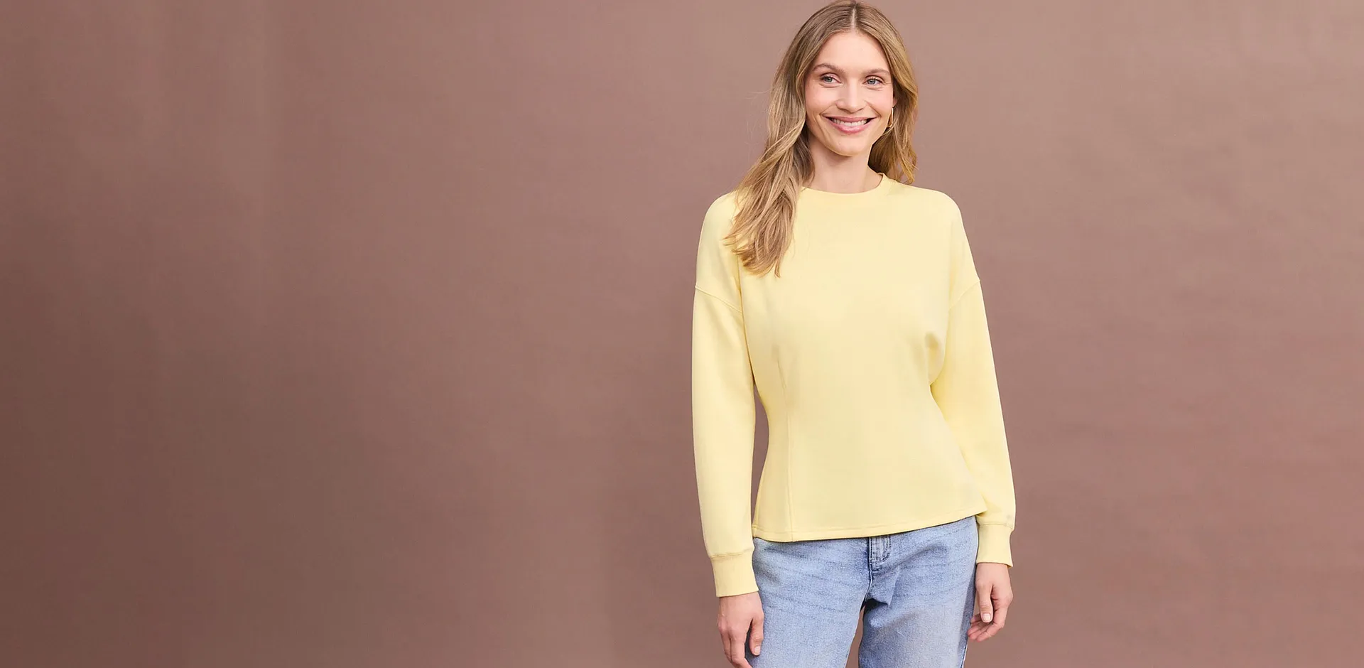 Braunes Langarmshirt mit einer bequemen blauen Jeans.