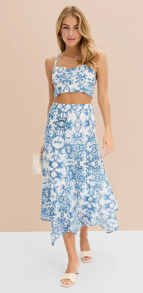 Sommerliches Zweiteiler-Outfit mit blau-weißem Blumenmuster: Crop-Top und langer Rock mit asymmetrischem Saum.