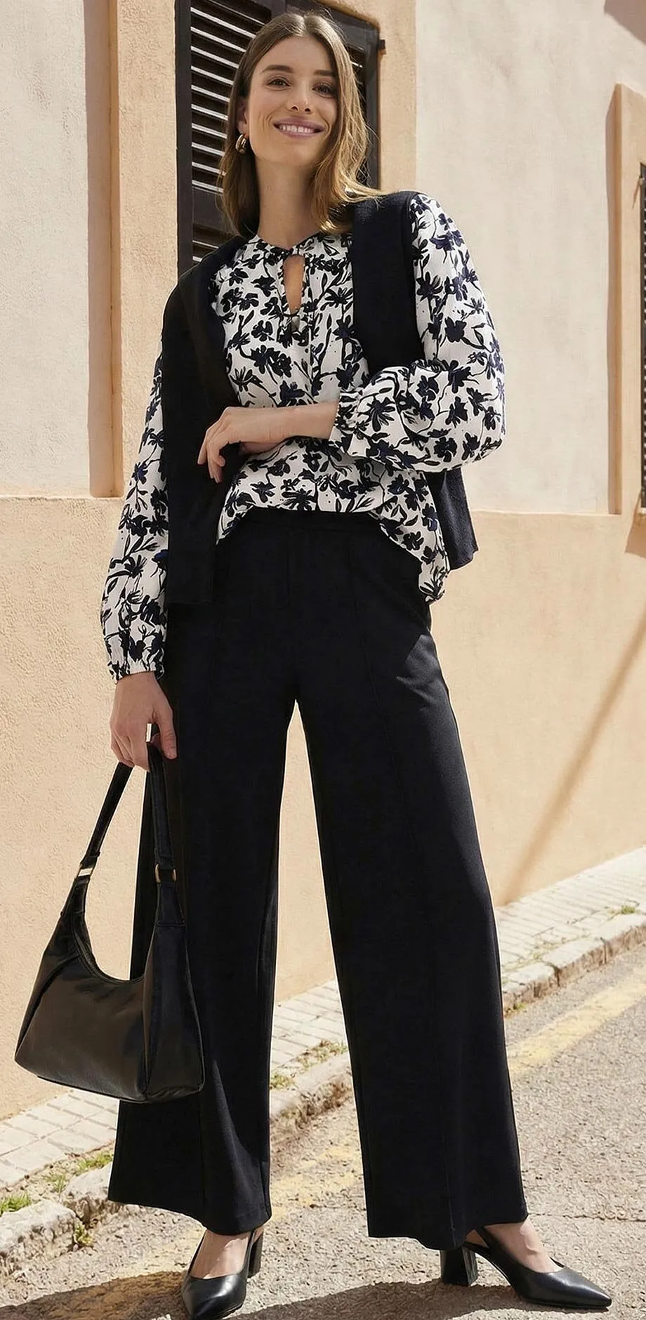 Pantalon noir associ&eacute; &agrave; un chemisier imprim&eacute; en noir et blanc.