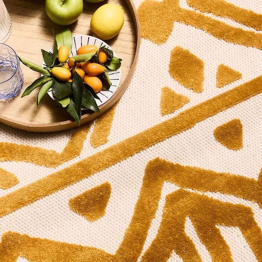 Tapis &agrave; motif g&eacute;om&eacute;trique jaune moutarde.