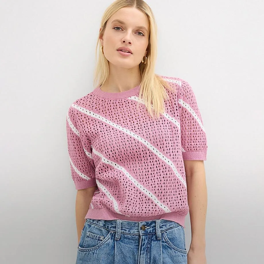 Pull rose ajour&eacute; avec rayures diagonales, associ&eacute; &agrave; un jean classique.