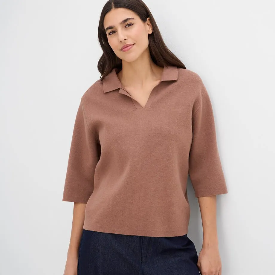 Modisches braunes Strick-Poloshirt mit Dreiviertel&auml;rmeln und dunklem Rock.