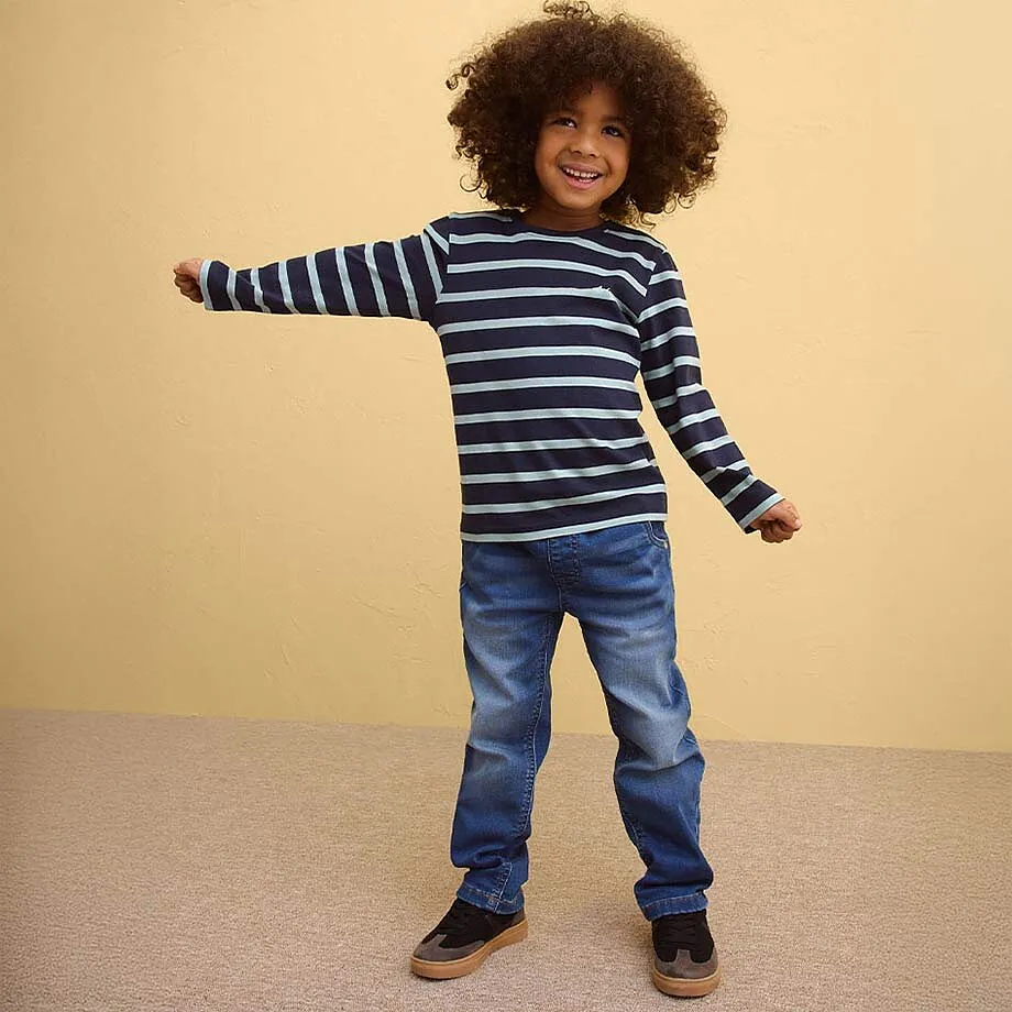 T-shirt ray&eacute; bleu et blanc &agrave; manches longues, associ&eacute; &agrave; un jean.