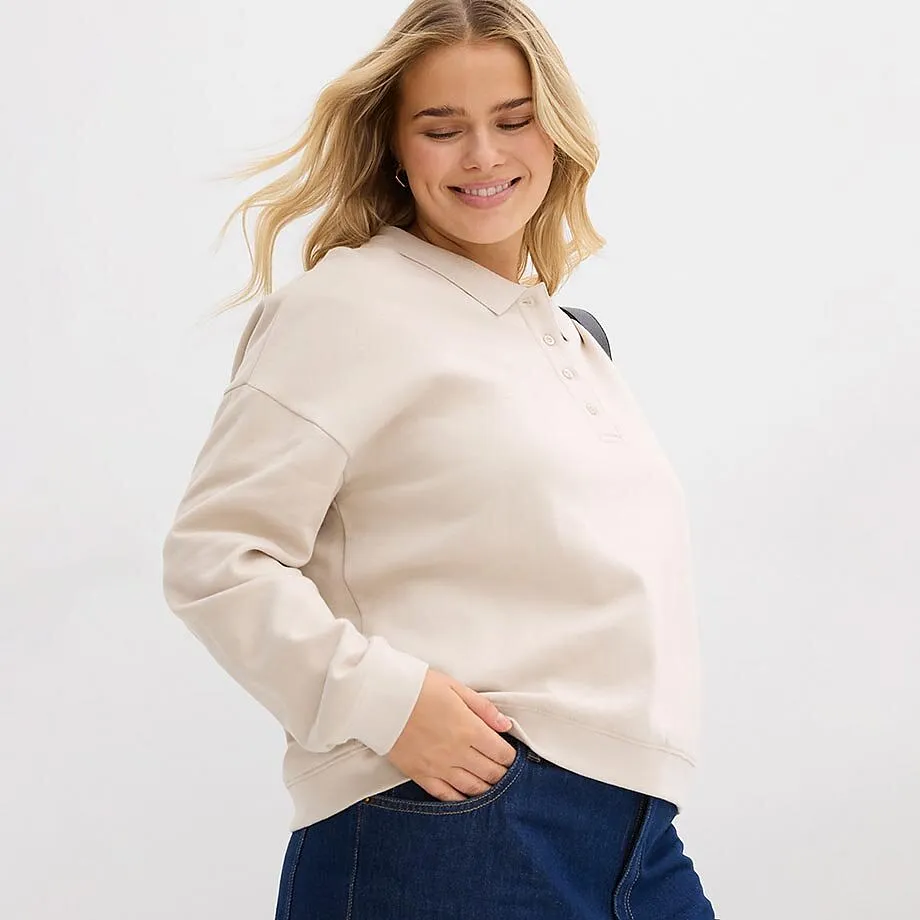 Sweat-shirt beige associ&eacute; &agrave; un jean classique.