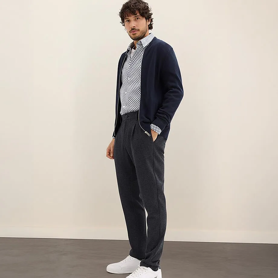 Gilet bleu marine, chemise &agrave; motifs et pantalon gris.